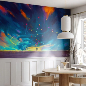 Fotomurali Premium Sand - Una figura con palloncini rivolta verso un cielo vorticoso pieno di colori - 100x70cm - Sul vento blu - Decorazione murale moderna per soggiorno e camera da letto ARTTOR