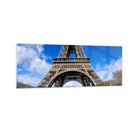Quadro su vetro - La Torre Eiffel sullo sfondo di un cielo azzurro e di un parco verde - 140x50cm - Tutta Parigi ai suoi piedi - Decorazione murale moderna per soggiorno e camera da letto ARTTOR