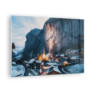 Quadro su vetro - Un villaggio invernale ai piedi di una parete rocciosa illuminata - 70x50cm - Lo spirito luminoso dell'inverno - Decorazione murale moderna per soggiorno e camera da letto ARTTOR