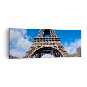 Quadro su tela - Stampe su Tela - La Torre Eiffel sullo sfondo di un cielo azzurro e di un parco verde - 140x50cm - Tutta Parigi ai suoi piedi - Decorazione murale moderna per soggiorno e camera da letto ARTTOR
