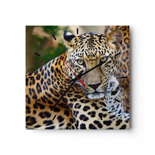 Orologio da parete - Orologio in Vetro - Giaguaro che riposa in un ambiente naturale con sfondo verde. - 30x30cm - Selvaggio e tranquillo - Decorazione murale moderna per soggiorno e camera da letto ARTTOR