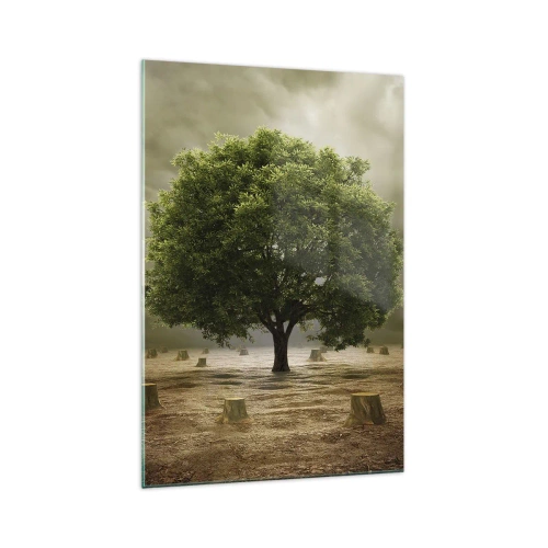 Quadro su vetro - Un albero verde circondato da tronchi d'albero abbattuti contro un cielo nuvoloso - 70x100cm - Ogni speranza - Decorazione murale moderna per soggiorno e camera da letto ARTTOR