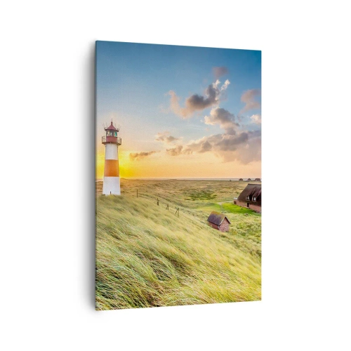 Quadro su tela - Stampe su Tela - Un faro con prati e case al sole sullo sfondo - 70x100cm - Tra le onde - Decorazione murale moderna per soggiorno e camera da letto ARTTOR