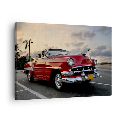 Quadro su tela - Stampe su Tela - Una decappottabile rossa classica parcheggiata tra le palme al tramonto. - 70x50cm - Il calore rosso dei tropici - Decorazione murale moderna per soggiorno e camera da letto ARTTOR