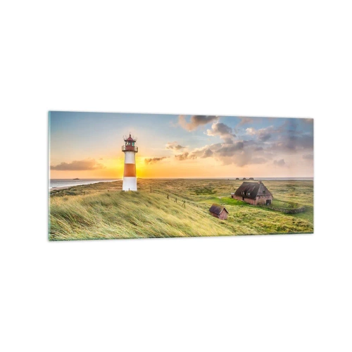 Quadro su vetro - Un faro con prati e case al sole sullo sfondo - 120x50cm - Tra le onde - Decorazione murale moderna per soggiorno e camera da letto ARTTOR