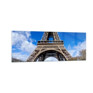 Quadro su vetro - La Torre Eiffel sullo sfondo di un cielo azzurro e di un parco verde - 140x50cm - Tutta Parigi ai suoi piedi - Decorazione murale moderna per soggiorno e camera da letto ARTTOR