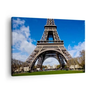 Quadro su tela - Stampe su Tela - La Torre Eiffel sullo sfondo di un cielo azzurro e di un parco verde - 70x50cm - Tutta Parigi ai suoi piedi - Decorazione murale moderna per soggiorno e camera da letto ARTTOR