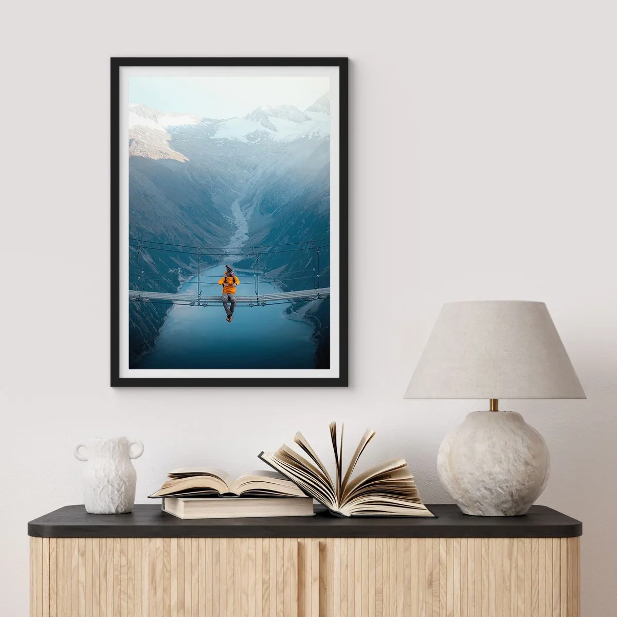 Poster in cornice nera - Una persona con una giacca gialla seduta su un ponte sospeso sopra una valle - 50x70cm - Colto in sospeso - Decorazione murale moderna per soggiorno e camera da letto ARTTOR