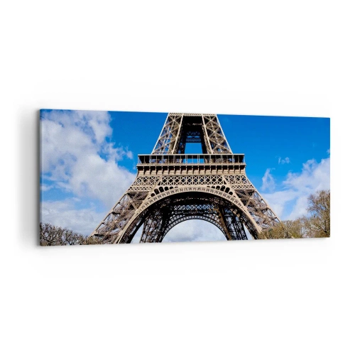 Quadro su tela - Stampe su Tela - La Torre Eiffel sullo sfondo di un cielo azzurro e di un parco verde - 120x50cm - Tutta Parigi ai suoi piedi - Decorazione murale moderna per soggiorno e camera da letto ARTTOR
