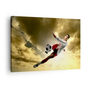 Quadro su tela - Stampe su Tela - Un giocatore di football in un salto dinamico che calcia la palla contro il cielo - 70x50cm - Il cielo del calcio - Decorazione murale moderna per soggiorno e camera da letto ARTTOR
