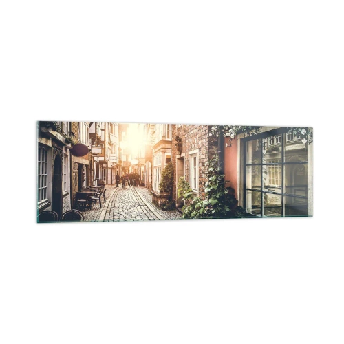 Quadro su vetro - Una strada affascinante con pavimentazione in pietra e fiori - 160x50cm - L'angolo delle rose nella luce rosata - Decorazione murale moderna per soggiorno e camera da letto ARTTOR