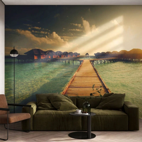 Fotomurali Standard Eco - Molo tropicale che conduce ai bungalow sull'acqua - 100x70cm - Caldo invito - Decorazione murale moderna per soggiorno e camera da letto ARTTOR